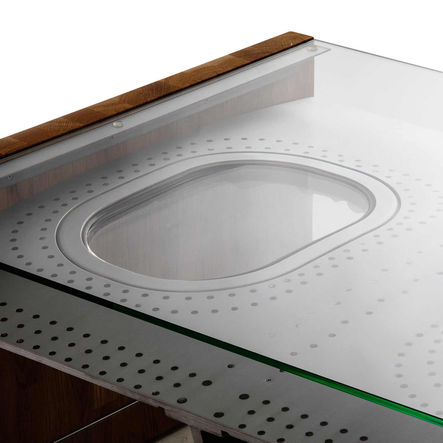 Moderner Designer-Tisch mit ovaler Glasfläche, runden Perforationen und Holzrahmen.